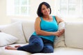 Portrait Of Overweight Woman Sitting On Sofa Royalty Free Stock Photo