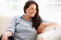 Portrait Of Overweight Woman Sitting On Sofa Royalty Free Stock Photo