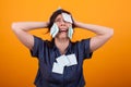 Portrait of overwhelmed business woman with work in studio over yellow background Royalty Free Stock Photo