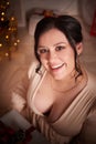 Portrait of Owerweight elegant Woman at Christmas room. Fat plumb pretty girl in a beautiful dress for a holiday Royalty Free Stock Photo