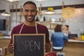 Portrait of owner with open sign in cafe Royalty Free Stock Photo