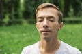 Portrait of the pacified face of a young attractive man with his eyes closed