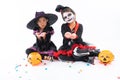 Portrait pair of little girls in Halloween and carnival costume on white background