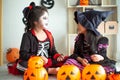 Portrait pair of little girls in Halloween and carnival costume on white background