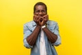 Portrait of panicked young man biting nails feeling anxious and terrified about problems. studio shot isolated on yellow Royalty Free Stock Photo