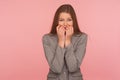 Portrait of panicking young woman in business suit biting nails, being nervous terrified, feeling frightened Royalty Free Stock Photo