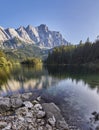 Portrait panorama of the crystal clear water of the Eibsee with the Zugspitze mountain including reflection in the background Royalty Free Stock Photo