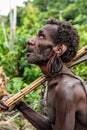 Portrait of papuan man with bow and arrows from Korowai Kolufo tribe