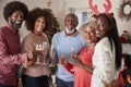 Portrait Of Parents With Adult Offspring Making A Toast With Champagne As They Celebrate Christmas Together Royalty Free Stock Photo