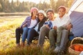 Portrait Of Parents With Children Camping By Lake