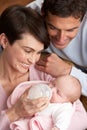 Portrait Of Parents Feeding Newborn Baby At Home Royalty Free Stock Photo