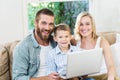 Portrait of parents and son using laptop in living room Royalty Free Stock Photo