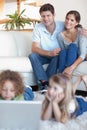 Portrait of parents watching their children using a laptop Royalty Free Stock Photo