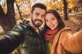 Portrait of passionate bonding couple girl guy make selfie in fall september park wear october coats Royalty Free Stock Photo