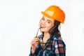 Portrait of passionate female builder with helmet and glasses touching her lips looking at camera and smiling Royalty Free Stock Photo