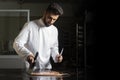 Pastry chef working on tempering chocolate on marble table