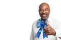 Portrait of a patriotic African american man giving thumbs up with Fourth of July bow tie white backdrop  with blank space for Royalty Free Stock Photo