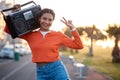 Portrait, peace sign and woman with radio in the street for skating, happiness or fashion. Smile, walking and young girl Royalty Free Stock Photo