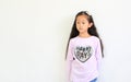 Portrait of peaceful asian little child girl looking beside isolated on white background with copy space