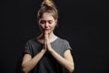 Portrait of peaceful european female holding palms in pray or namaste greeting