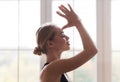 Portrait of peaceful girl practicing yoga at home