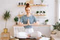 Portrait of peaceful meditating redhead young woman is putting her hands together Royalty Free Stock Photo