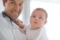 Portrait, pediatrician and holding baby in clinic assessment, medical support and growth. Newborn kids, happy man and