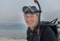 Portrait of pensioner in underwater diver basic equipment. Popular water sport and leisure activity