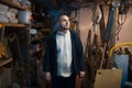 Portrait of pensive adult man in his workshop room