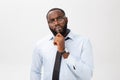 Portrait of a pensive African American businessman in a gray suit thinking with pen on his hand. Royalty Free Stock Photo