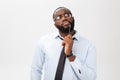 Portrait of a pensive African American businessman in a gray suit thinking with pen on his hand. Royalty Free Stock Photo