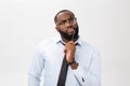 Portrait of a pensive African American businessman in a gray suit thinking with pen on his hand. Royalty Free Stock Photo