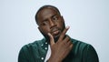 Portrait of pensive african american guy thinking on grey background.