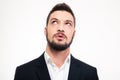 Portrait of pensive attractive young man thinking and looking up