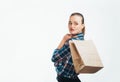 Portrait pensive beautiful woman holding package with purchases after shopping isolated on white background.