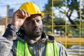 portrait of pensive black man builder at construction site