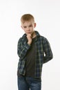 Portrait of a pensive boy in a plaid shirt on a white background Royalty Free Stock Photo