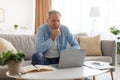 Portrait of pensive mature using laptop at home Royalty Free Stock Photo