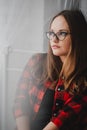 Portrait of a pensive girl in glasses and a checkered shirt Royalty Free Stock Photo