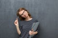 Portrait of pensive girl holding folder and pen Royalty Free Stock Photo