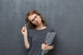 Portrait of pensive girl holding folder and pen Royalty Free Stock Photo