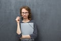 Portrait of pensive girl holding folder and pen Royalty Free Stock Photo