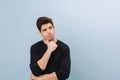 Portrait of a pensive handsome young man standing