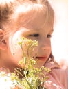 Portrait of pensive little girl, Beautiful day dreaming little girl holding bouquet spring yellow flowers Royalty Free Stock Photo