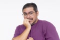 Portrait of a pensive man biting his fingernail with a curious expression, isolated on a white background Royalty Free Stock Photo