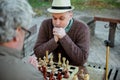 Serious old mates playing chess on fresh air Royalty Free Stock Photo