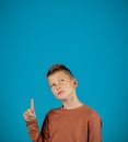 Portrait Of Pensive Preteen Boy Having Idea, Pointing Finger Up Royalty Free Stock Photo