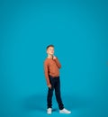 Pensive Preteen Boy Touching Chin And Looking Up At Copy Space Royalty Free Stock Photo