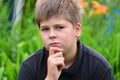 Portrait pensive teen boy on nature