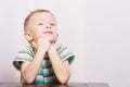 Portrait of pensive thoughtful blond boy child kid at the table Royalty Free Stock Photo